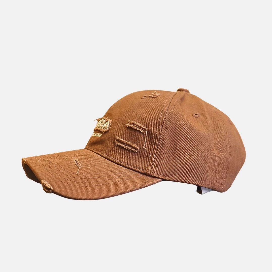 Side view of brown distressed baseball cap with embroidery